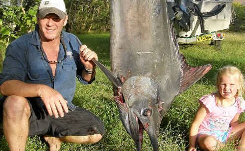David Ensbey, with a young onlooker, proudly displays the weighty black marlin he and his mates caught on the weekend. David Ensbey, with a young onlooker, proudly displays the weighty black marlin he and his mates caught on the weekend.